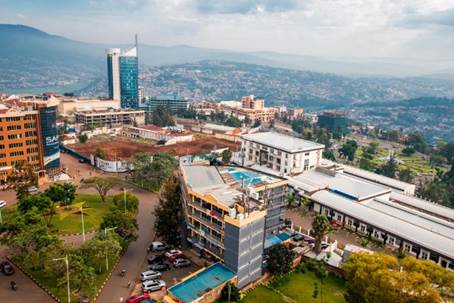 Kigali, Rwanda - September 21, 2018: a wide panoramic view looking down on the city centre with Kigali City Tower against the backdrop of distant blue hills. Photo: Shutterstock / Jennifer Sophie